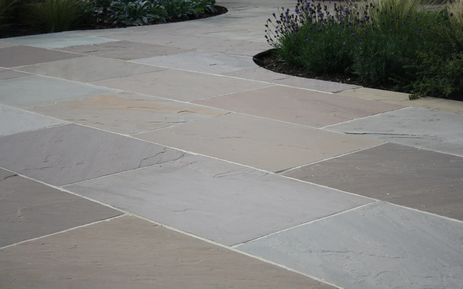 Lakeland Classicstone pavers, featuring soft grays and earthy tones, are ideal for creating stylish and welcoming outdoor patios.