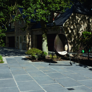 Charcoal Classicstone pavers add a modern touch to outdoor spaces with their striking color and enduring quality.