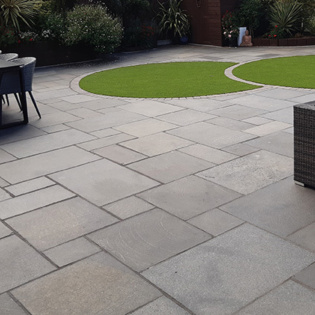 Charcoal stone pavers deliver a contemporary edge to patios, combining durability with a striking, modern aesthetic.