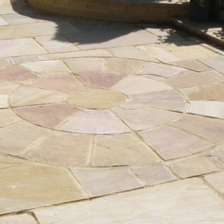 Enhance your patio with elegant stone pavers and a circle kit, creating a charming outdoor space perfect for relaxation and gatherings.