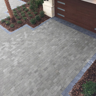 A refined driveway designed with natural stone pavers, providing a classic and welcoming look to the property.