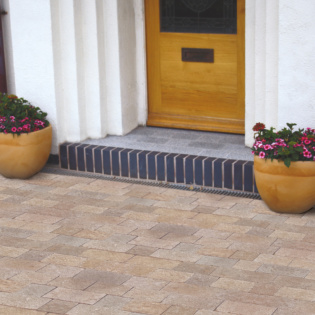 A picturesque driveway composed of natural stone pavers, enhancing the curb appeal of the home.