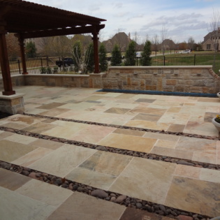 Golden Fossil pavers add a touch of elegance to patios, showcasing beautiful stone patterns and exceptional durability.