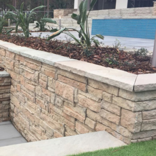 Enhance your outdoor space with chiseled natural stone pool coping, perfect for seating walls, adding elegance and charm to your pool area.