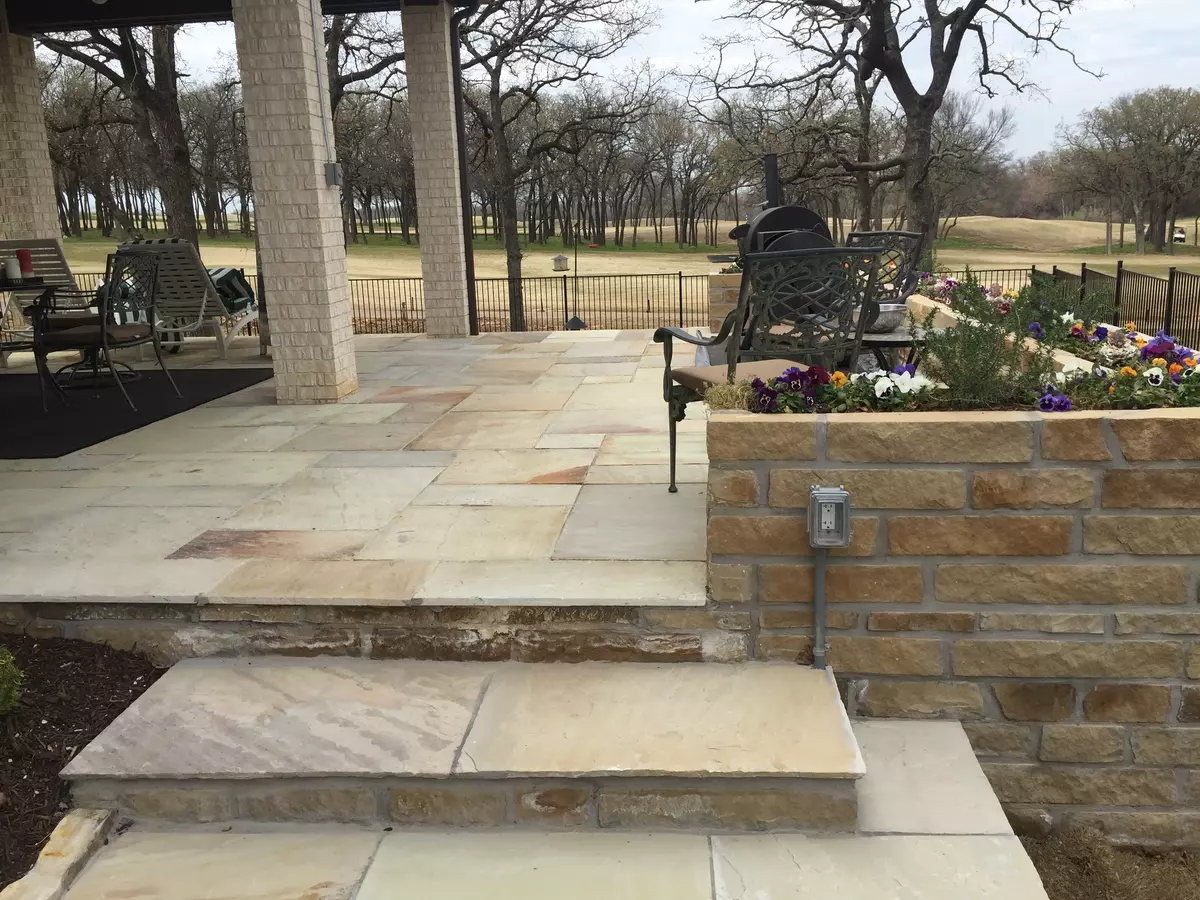 Golden Fossil natural stone patio pavers showcasing unique fossil patterns and warm hues, perfect for outdoor spaces.