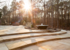 Golden Fossil paving stones bring a warm, natural glow to outdoor patios, creating a stunning visual appeal with their unique stone designs.