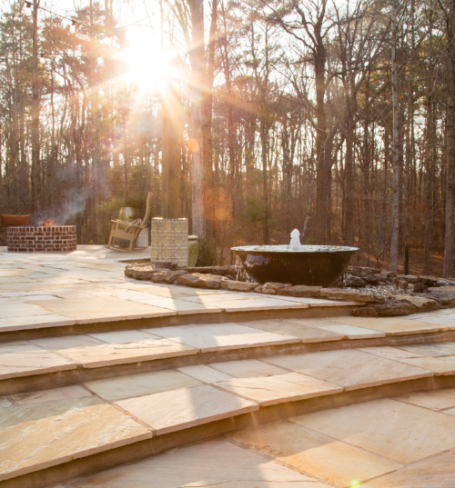 Golden Fossil paving stones bring a warm, natural glow to outdoor patios, creating a stunning visual appeal with their unique stone designs.