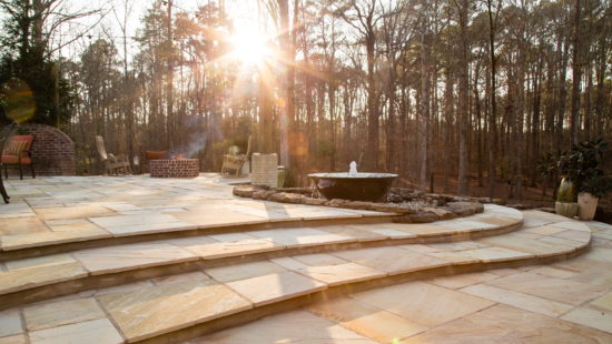 Golden Fossil paving stones bring a warm, natural glow to outdoor patios, creating a stunning visual appeal with their unique stone designs.